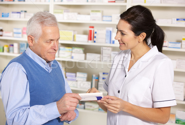 Stock photo: American pharmacist serving  senior man in pharmacy