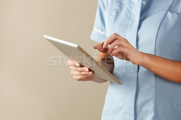 UK nurse using computer tablet Stock photo © monkey_business