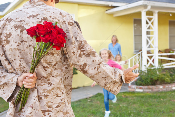 Stock photo: Family Welcoming Husband Home On Army Leave