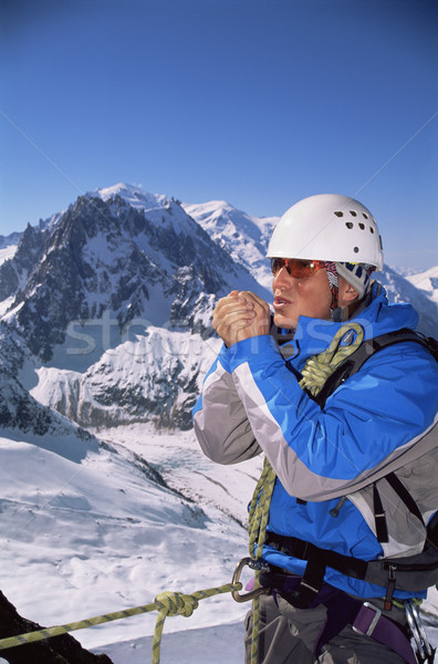 Young man warming hands on mountain peak Stock photo © monkey_business