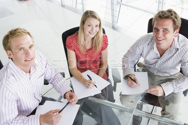 Trois gens d'affaires boardroom paperasserie souriant affaires [[stock_photo]] © monkey_business