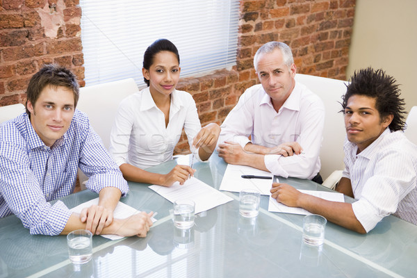 Four businesspeople in boardroom smiling Stock photo © monkey_business