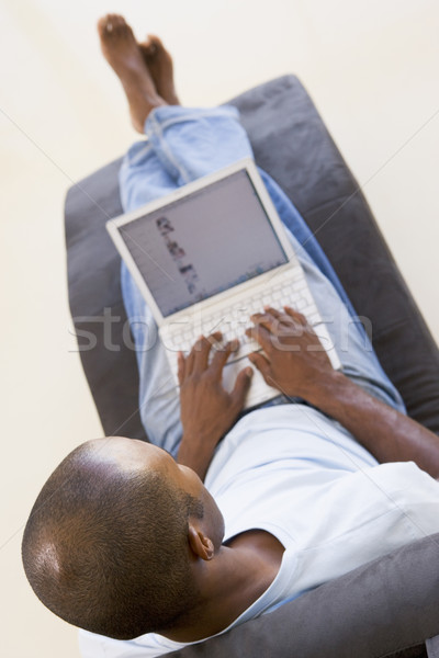 Stock photo: Man sitting in chair using laptop