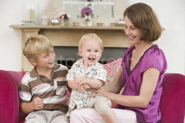Mother in living room with baby and young boy smiling Stock photo © monkey_business