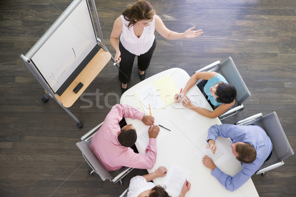 Négy üzletemberek tárgyaló asztal néz bemutató Stock fotó © monkey_business