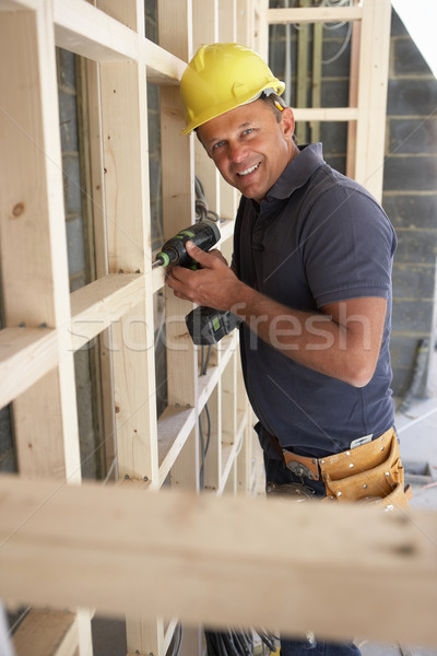 Construction Worker Building Timber Frame In New Home Stock photo © monkey_business