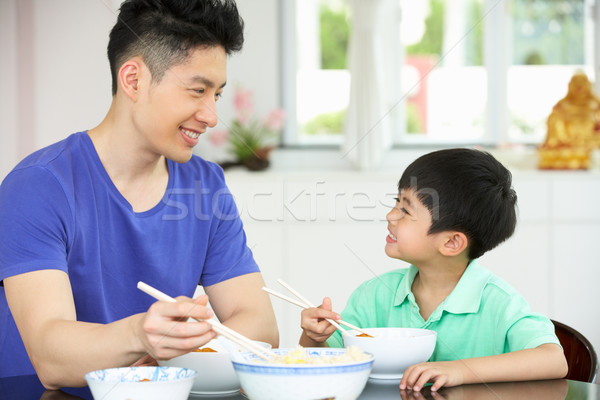Chinese Father And Son Sitting At Home Eating A Meal Stock photo © monkey_business