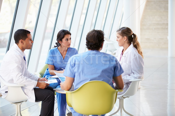 Medical Team Meeting Around Table In Modern Hospital Stock photo © monkey_business