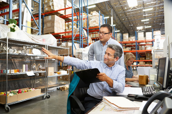 Business Colleagues Working At Desk In Warehouse Stock photo © monkey_business