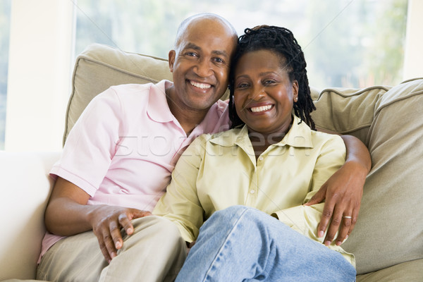 Stock photo: Couple relaxing in living room and smiling