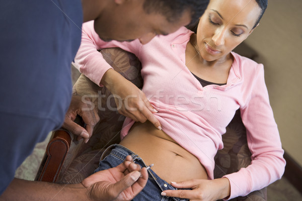 Stock photo: Man helping woman inject drugs to achieve pregnancy