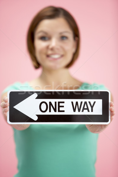 Stock photo: Woman Holding Road Traffic Sign