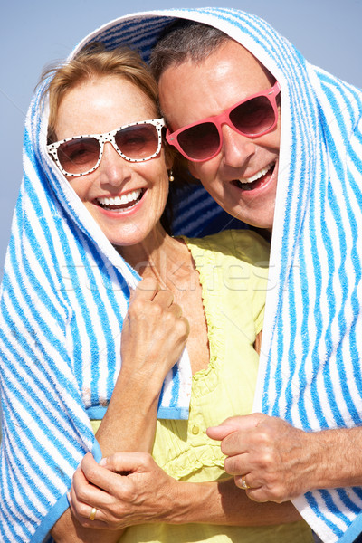 Senior Couple Sheltering From Sun On Beach Holiday Stock photo © monkey_business