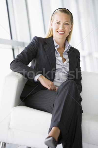 Businesswoman sitting in office lobby smiling Stock photo © monkey_business