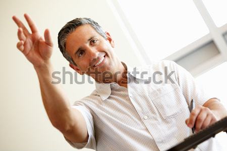 Man with winning lottery ticket excited and smiling Stock photo © monkey_business