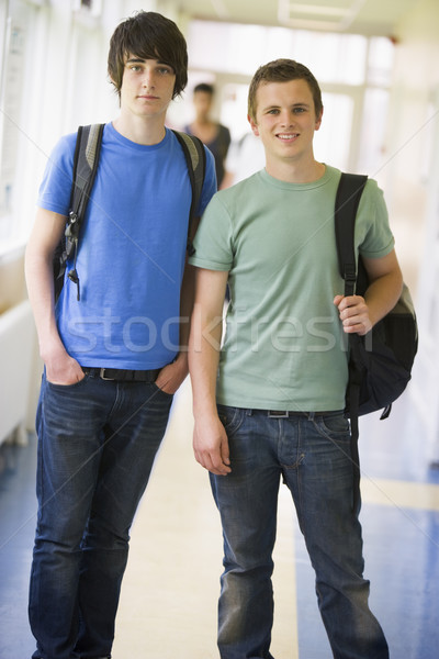 Stock photo: Male college students standing in university corridor