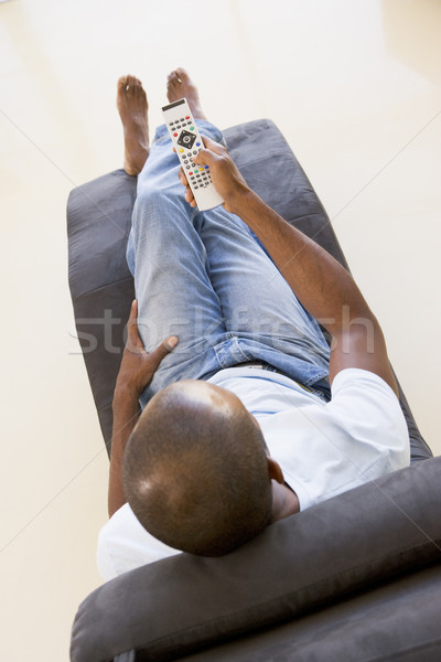 Man vergadering stoel afstandsbediening mannelijke Blur Stockfoto © monkey_business