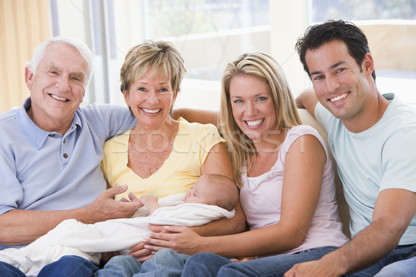 Stock photo: Family in living room with baby smiling