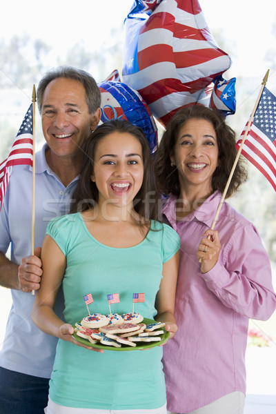 Stock photo: Family outdoors on fourth of July with flags and cookies smiling