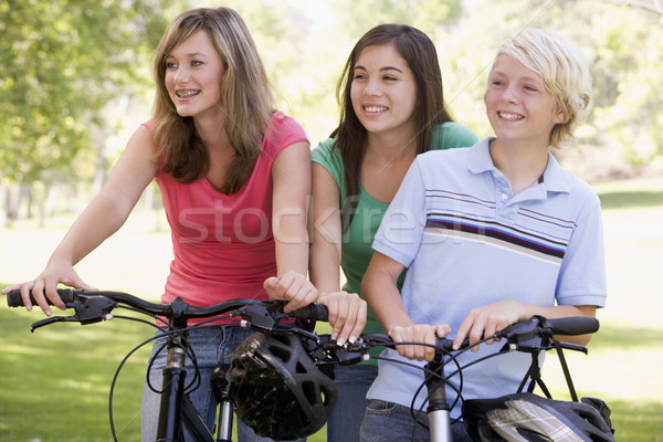 Tinédzserek biciklik barátok lányok bicikli park Stock fotó © monkey_business