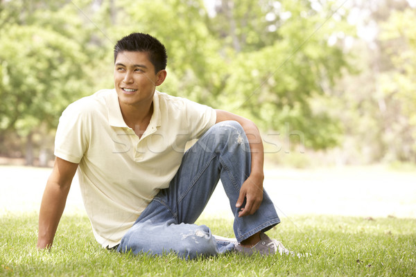 Stock photo: Portrait Of Young Man Sitting In Park