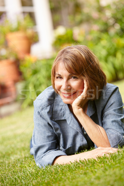 Mid age woman relaxing in garden Stock photo © monkey_business