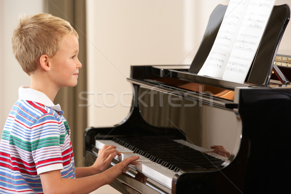 Young boy playing grand piano at home Stock photo © monkey_business