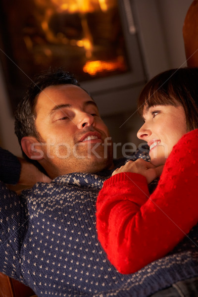 Middle Aged Couple Chatting On Sofa By Cosy Log Fire Stock photo © monkey_business