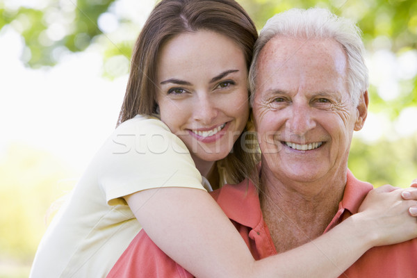 Man and woman outdoors embracing and smiling Stock photo © monkey_business