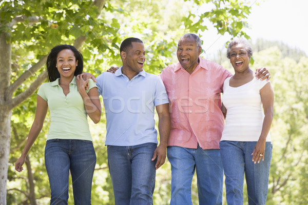 Stock photo: Two couples walking outdoors arm in arm smiling