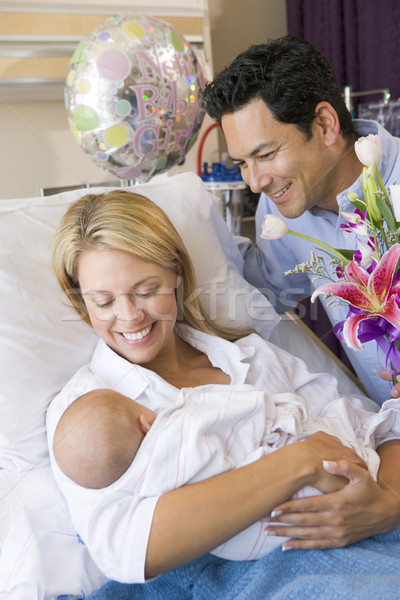 New mother with baby and husband in hospital smiling Stock photo © monkey_business