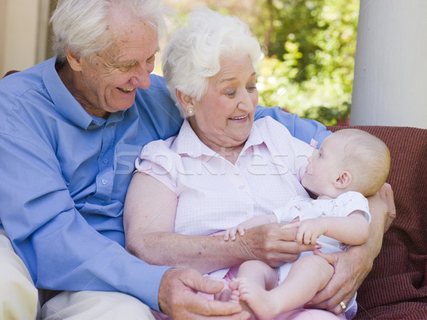 Stock photo: Grandparents outdoors on patio with baby smiling