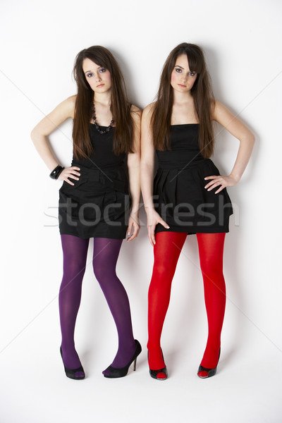 Studio Portrait Of Fashionably Dressed Twin Teenage Girls Stock photo © monkey_business