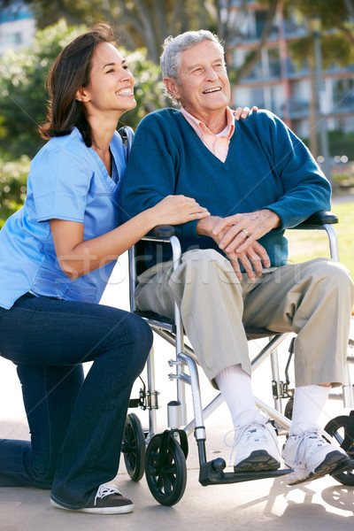 Carer Pushing Senior Man In Wheelchair Stock photo © monkey_business