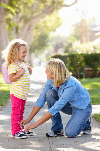 Mother Helping Daughter Tie Shoe Laces On Walk To School Stock photo © monkey_business