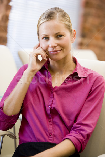 Businesswoman sitting in office space smiling Stock photo © monkey_business