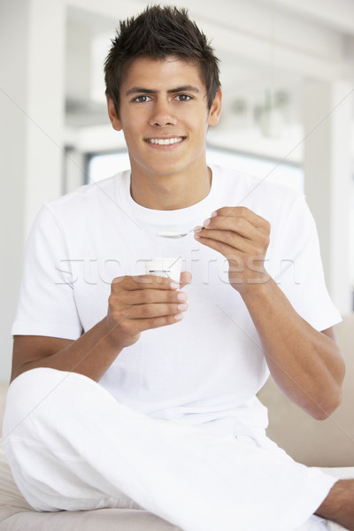 Stock photo: Young Man Eating Yogurt