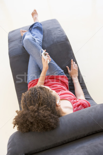 Nő ül szék hallgat mp3 lejátszó otthon Stock fotó © monkey_business