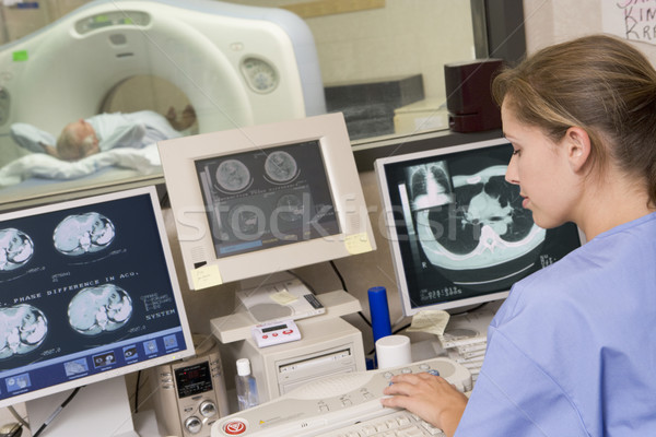 Stock photo: Nurse Monitoring Patient Having A Computerized Axial Tomography 