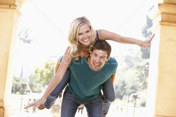 Young Man Giving Woman Piggyback Outdoors Stock photo © monkey_business