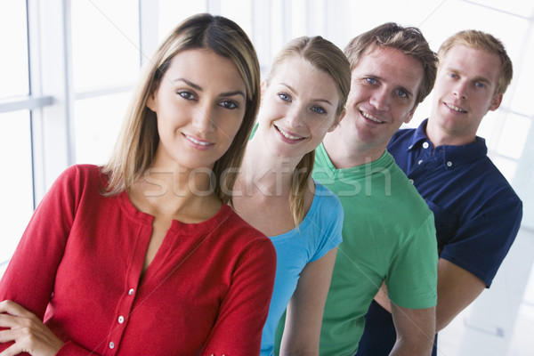 Cuatro personas pie corredor sonriendo hombre equipo Foto stock © monkey_business