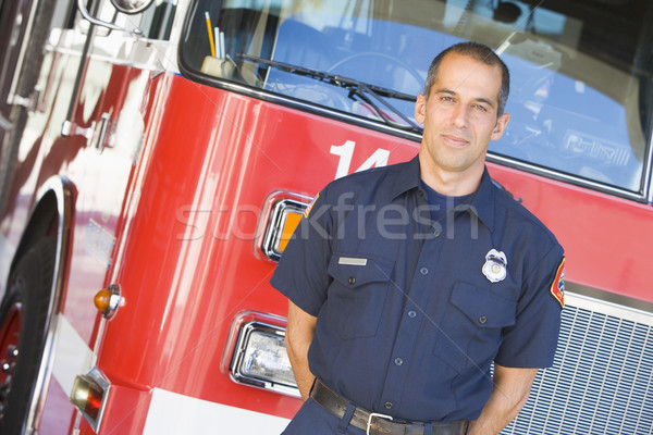 Portrait of a firefighter by a fire engine Stock photo © monkey_business