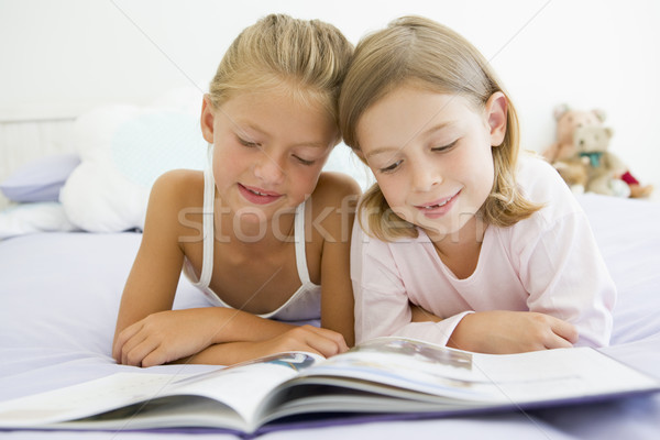 Two Young Girls In Their Pajamas, Reading A Book Stock photo © monkey_business