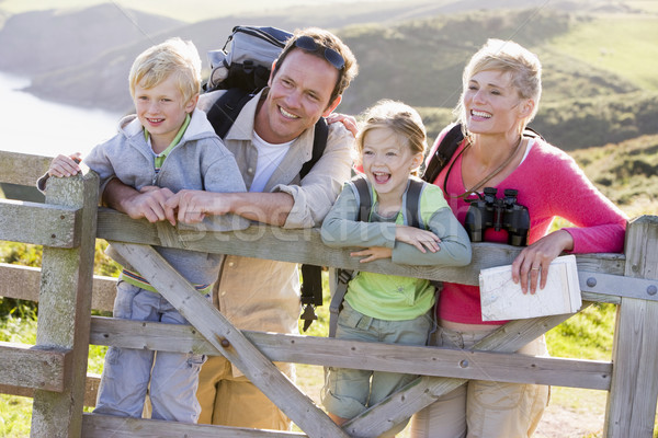 Stock photo: Family on cliffside path leaning on fence and smiling