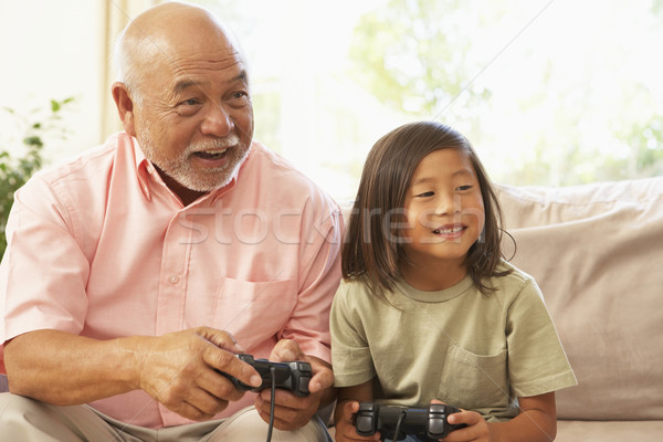 Bunic nepot joc joc pe calculator acasă băiat Imagine de stoc © monkey_business
