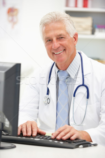 Senior doctor at desk Stock photo © monkey_business
