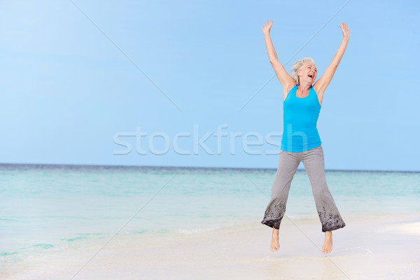 Senior mulher saltando belo praia mulheres Foto stock © monkey_business