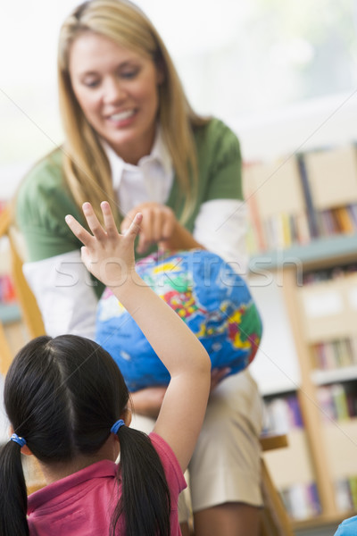 Stock photo: Kindergarten teacher and children looking at globe