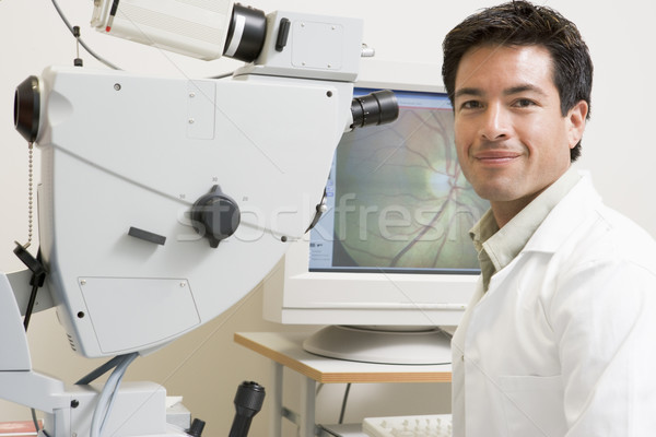 Portrait Of A Doctor Next To An Eye Exam Machine Stock photo © monkey_business