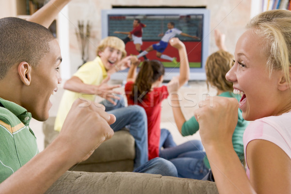 Stock photo: Teenagers Hanging Out In Front Of Television 